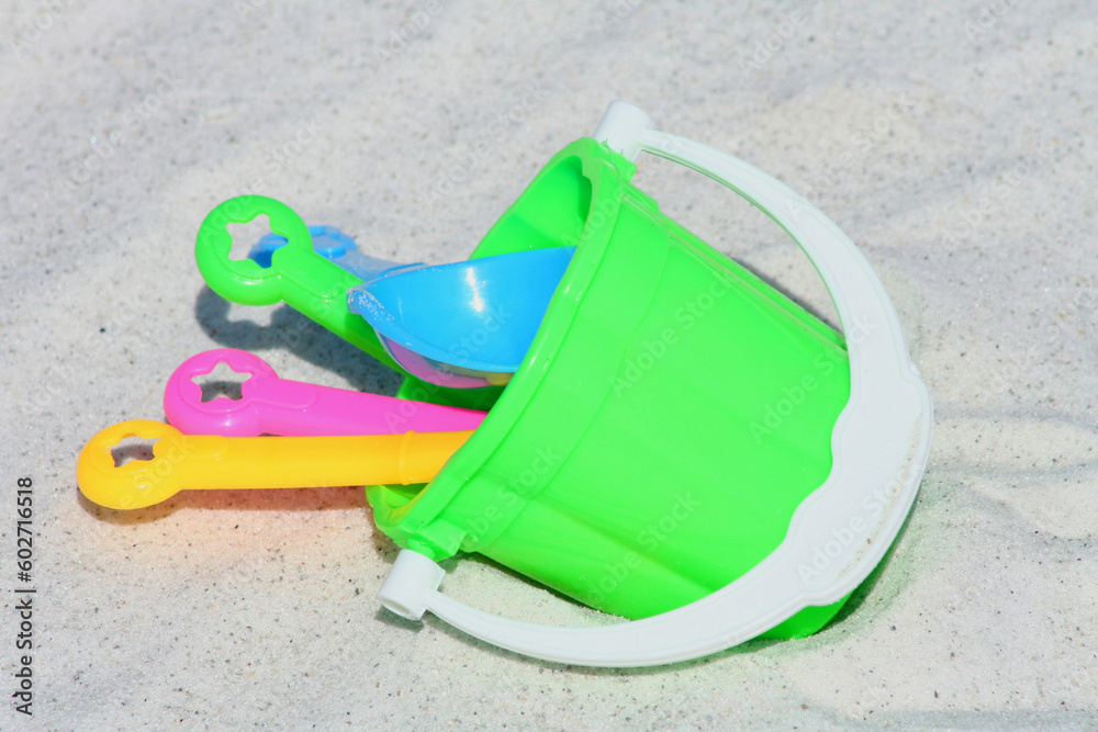 Bucket and spades on the sand in a beach day Bucket and spades on the sand in a beach day