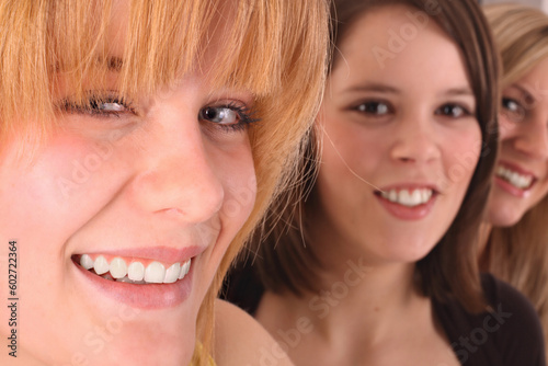 smiling teens - front girl with bangs hair style