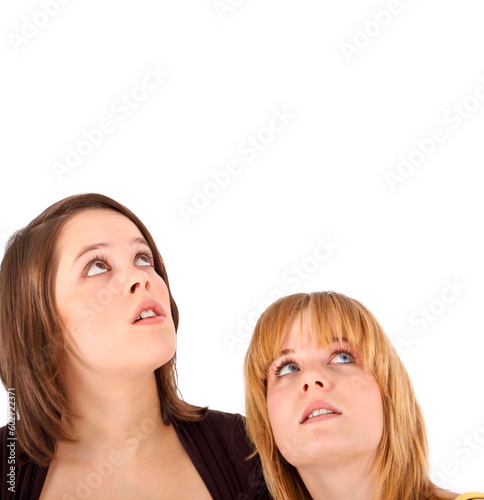 two young teens with a frightning look up (isolated on white)