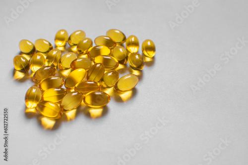 yellow omega 3 capsule on white surface