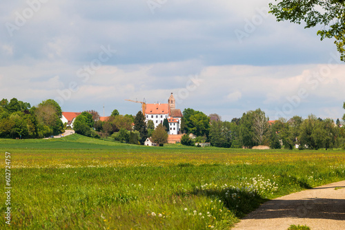 View of the Gablinger castle over the green meadows and fields in the Schmutter valley near Augsburg