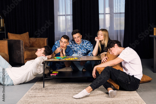 Five friends spending time together, get bored. Small group of friend in a living room, boring party or friends meeting.