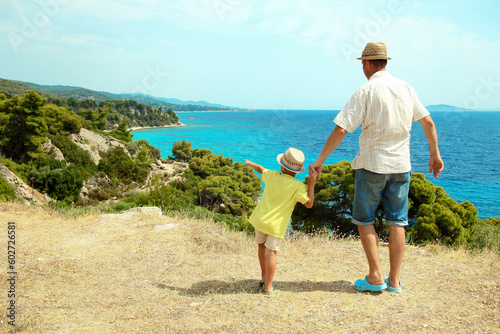 A hands of happy parents and children at sea in travel background in greece © Kostia