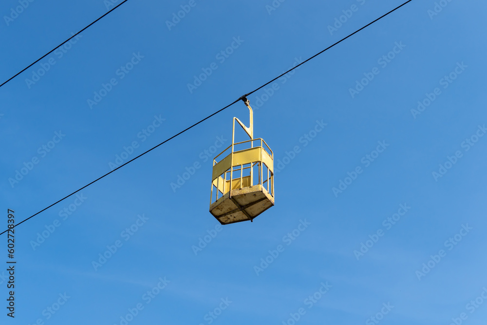 Abandoned cabin cableway for transporting people in amusement park. Old obsolete suspension road across river. Vintage rusty cable car in the city Dnepr. Soviet union technology and attractions USSR.