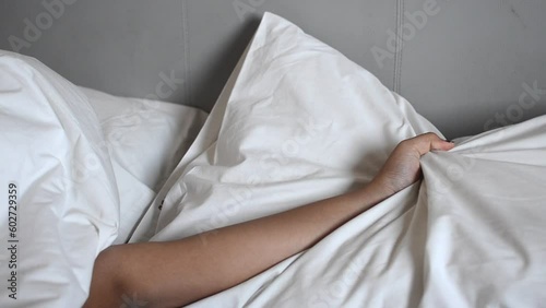 woman hands squeezing pillow passionately illustrating sex intimacy photo