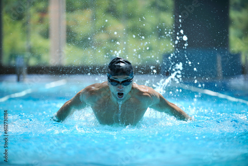 young healthy with muscular body man swim on swimming pool and representing healthy and recreation concept