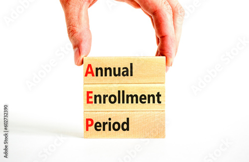 AEP symbol. Concept words AEP Annual enrollment period on beautiful wooden block. Doctor hand. Beautiful white table white background. Medical and AEP Annual enrollment period concept. Copy space. photo