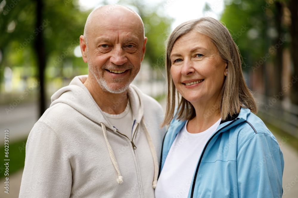 Portrait of the Mature Couple Smiling and Looking at the Camera. Mature Man Looking at the Camera while His Wife Looking at Him than to the Camera. Love and Communication Concept Portrait of the Mature Couple Smiling and Looking at the Camera. Mature Man Looking at the Camera while His Wife Looking at Him than to the Camera. Love and Communication Concept