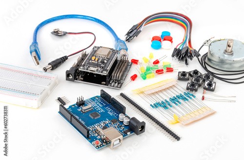 Electronic DIY project Arduino with peripherals and expansion cards lie on a white background. Electronics and microprocessor.Do it yourself. Programming and training
