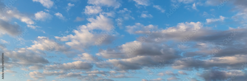 Blue sky with white curly clouds in sunny weather