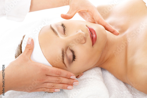 Young beautiful and relaxed lady taking spa treatment