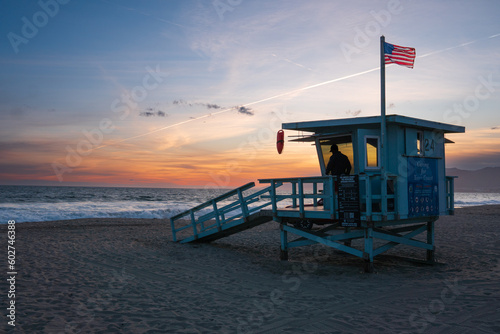 Santa Monica, USA. A lifeguard tower at sunset, silhouette of a lifeguard inside.