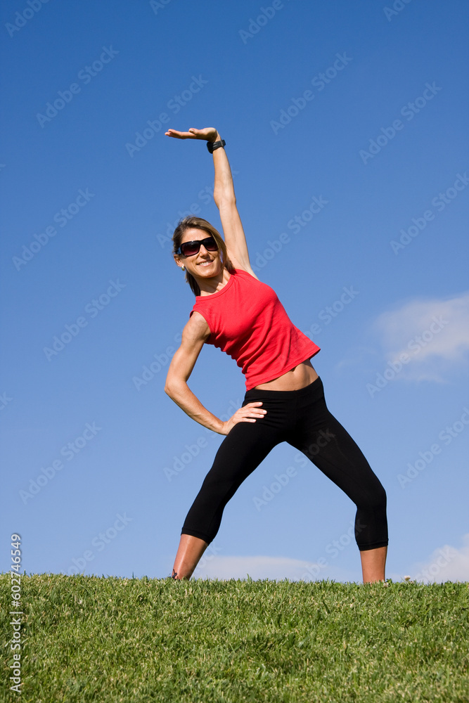 Young pretty woman exercising isolated on blue sky Young pretty woman exercising isolated on blue sky