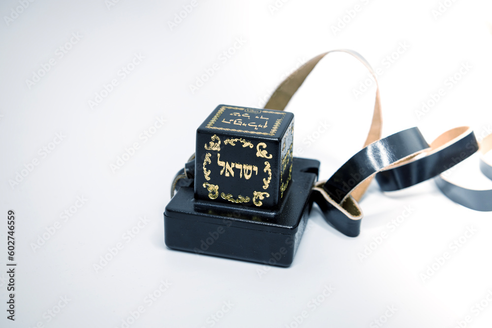 Tefillin or phylacteries . Pair of black leather boxes for the arm and