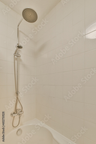 a bathtub with the shower head in it's position and hands on the edge of the tubpipe