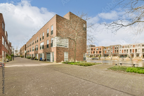 a brick building in the middle of an urban area with trees and buildings on either side of the street,