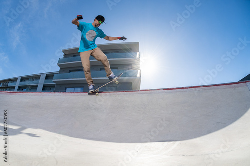Skateboarder doing backside five-o grind trick