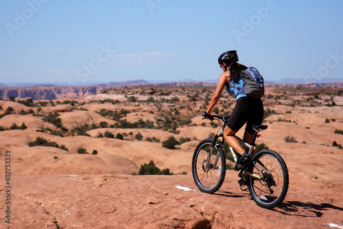 Female biker on slick rock in Moab, Utah