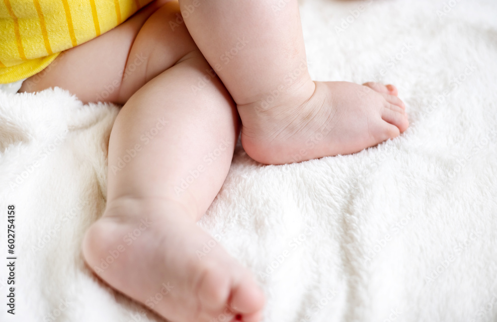 adorable cute baby boy infant toddler sleeping on bed blanket close up face parts small fat little hands,legs feet,barefoot child.new born in yellow bodysuit sweet dreams cute maternity big cheeks