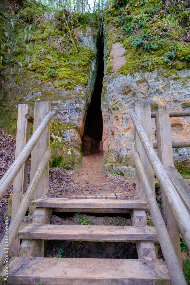 Red sandstone cliffs. Entrance to the cave in Gauja park, Sigulda, Latvia