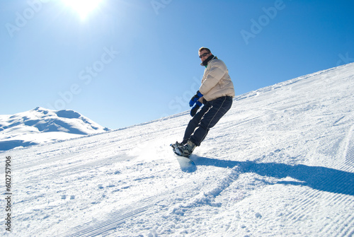 Snowboarding on a mountain in a bright sunny day stock photo