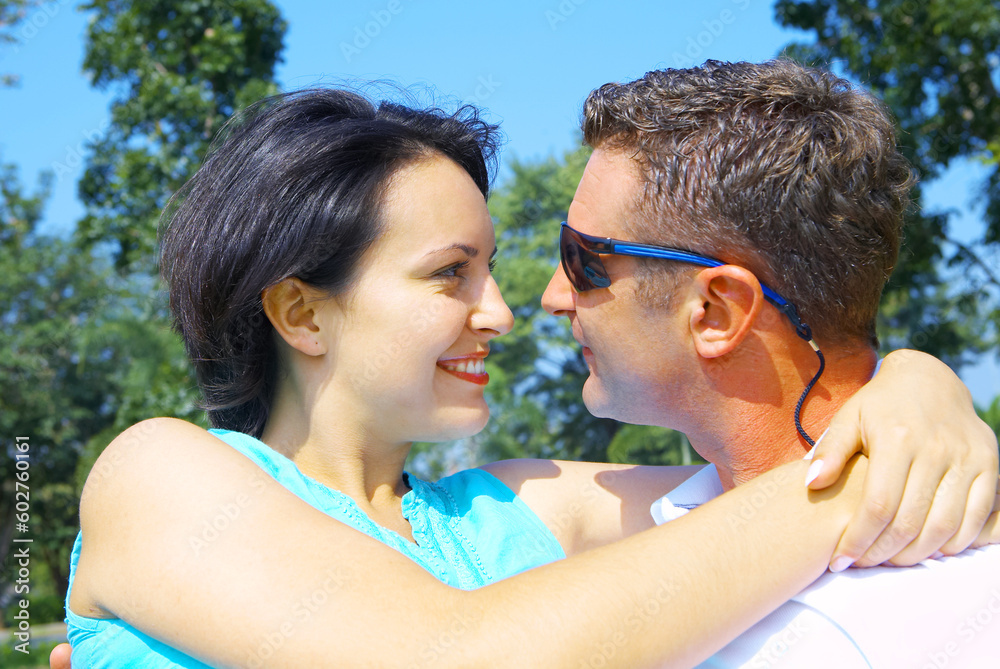 a portrait of attractive couple in summer environment