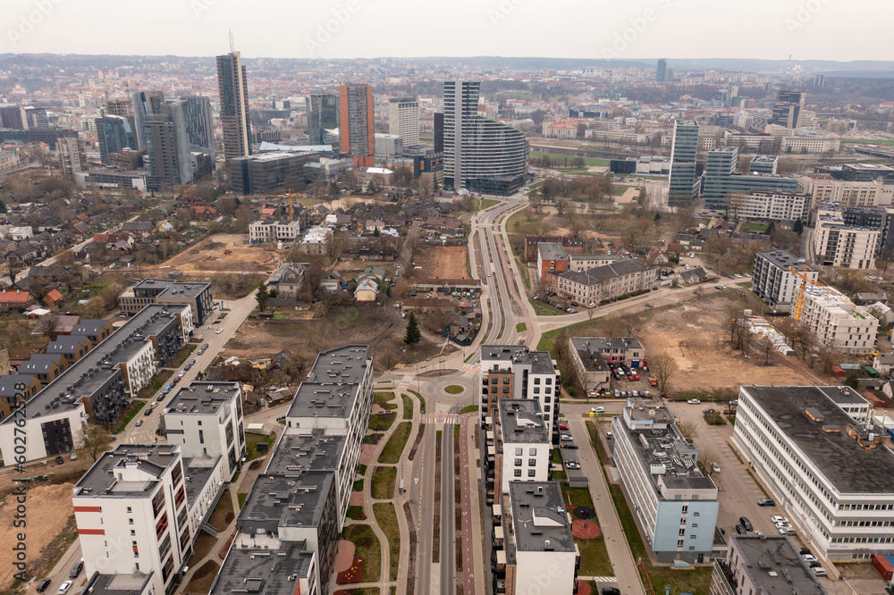 Obraz premium Drone photography of new high rise skyscrapers and old residential houses.