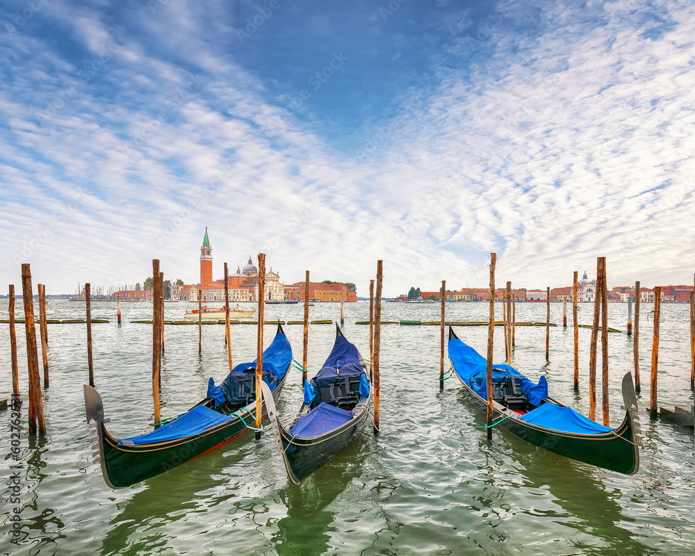 Captivating  landscape with Church of San Giorgio Maggiore on background and gondolas parked beside the Riva degli Schiavoni in Venice