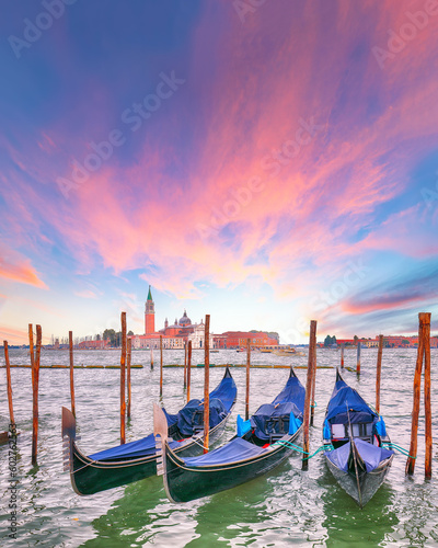 Captivating landscape with Church of San Giorgio Maggiore on background and gondolas parked beside the Riva degli Schiavoni in Venice