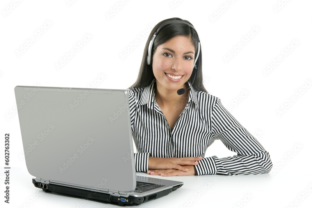 Beautiful young businesswoman talking with headset phone over white background