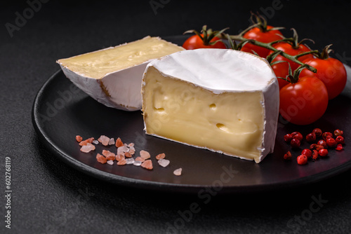 Delicious fresh brie cheese in the form of a mini head with cherry tomatoes