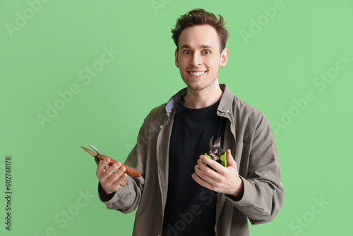Young man with secateurs on...
