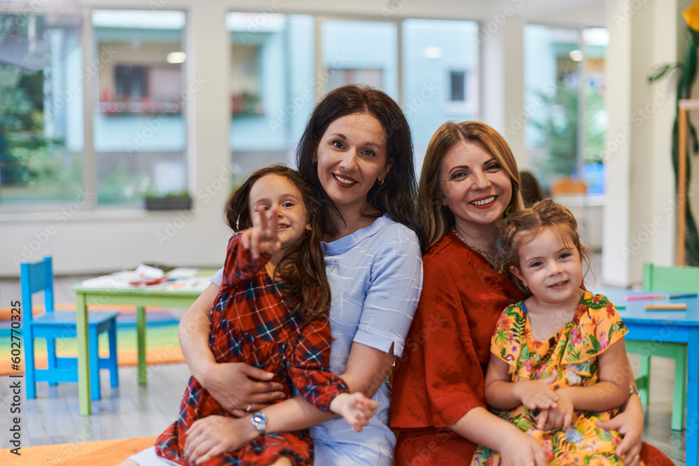A child hugging a teacher in a modern kindergarten A child hugging a teacher in a modern kindergarten