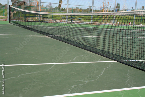Tennis court during day time in a park.