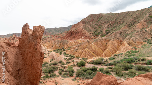 Scenery from Fairytale Canyon, unique rock formation located in Kyrgyzstan. Canyon is known for its unusual and colorful rock formations, which have been shaped over time by wind and water erosion.