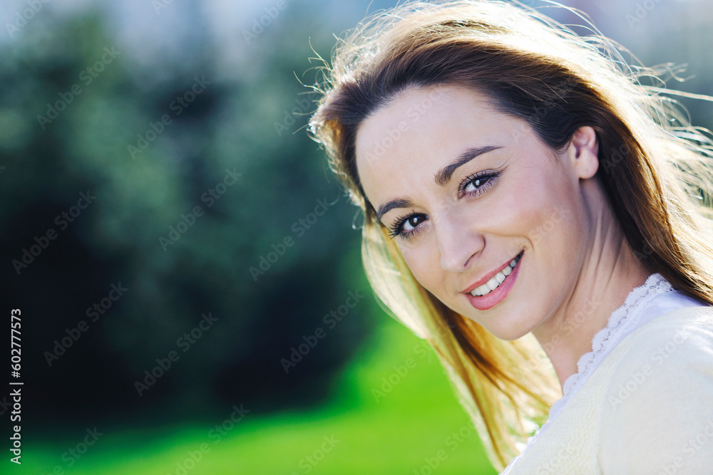 Obraz premium happy young beautiful woman face closeup and portrait outdoor at sunny day