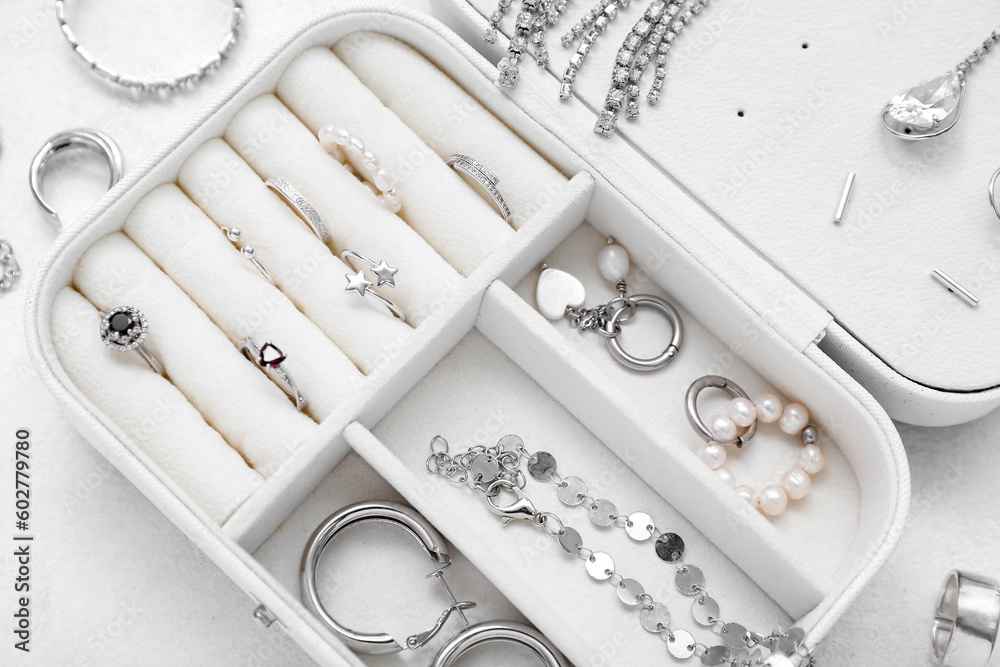 Opened organizer with stylish jewelry on white background Opened organizer with stylish jewelry on white background