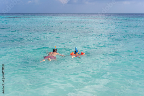 Dad teaches son to snorkel in the Maldives © Marina