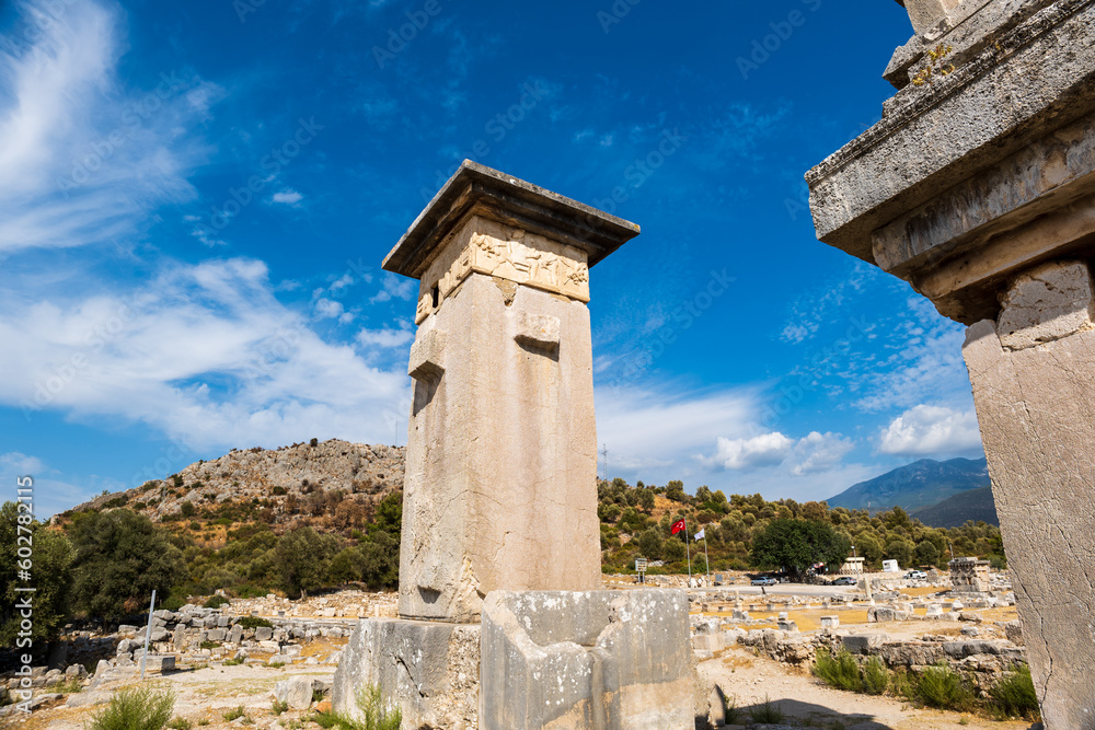 Xanthos Ancient City archaeology site. Grave monument and the ruins of ancient city of Xanthos in Kas, Antalya, Turkey at sunset. Capital of Lycia.
