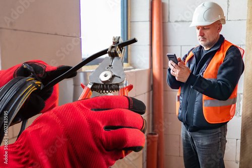 Man builder. Hands of elect...