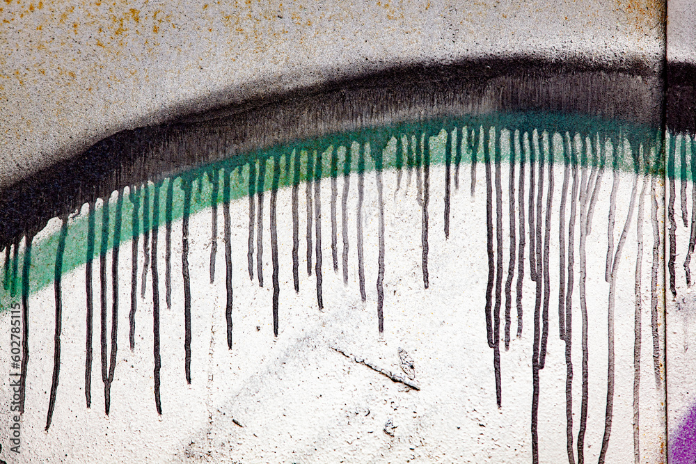 Old colorful street art background. Fragment of the old graffiti. Spoiled paint texture.