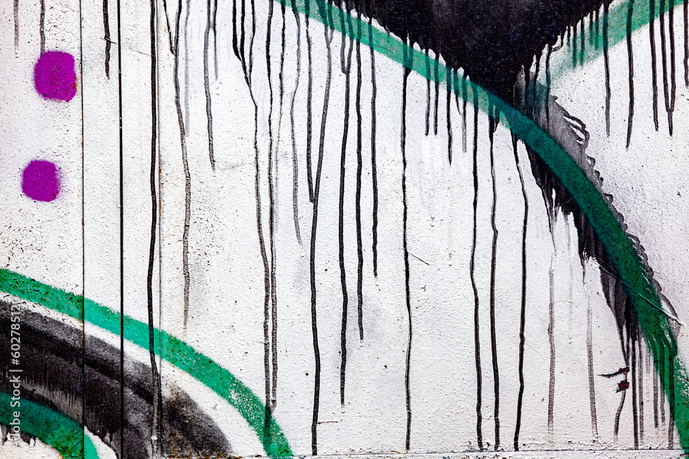 Old colorful street art background. Fragment of the old graffiti. Spoiled paint texture.