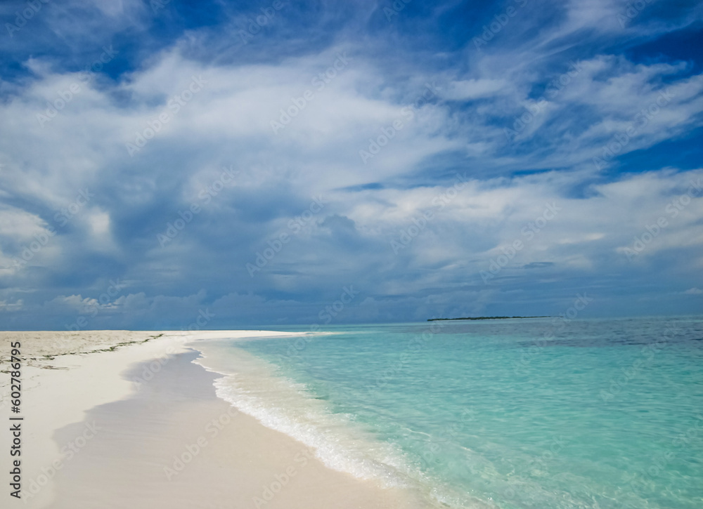 Relaxing amazing view to stunning sandy beach blue turquoise water. Warm sunny day on the beach with ocean and blue sky.