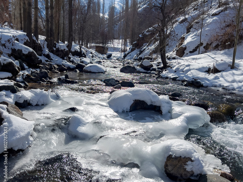 Partially frozen river in the mountain