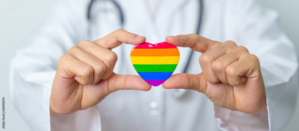 LGBT pride month or LGBTQ+ or LGBTQIA+ and health concept. Doctor with rainbow and colorful heart shape with for Lesbian, Gay, Bisexual, Transgender, Queer and Pansexual community