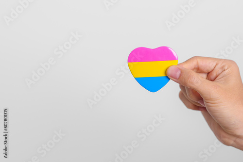Pansexual Pride Day and LGBT pride month concept. hand holding pink  yellow and blue heart shape for Lesbian  Gay  Bisexual  Transgender  Queer and Pansexual community