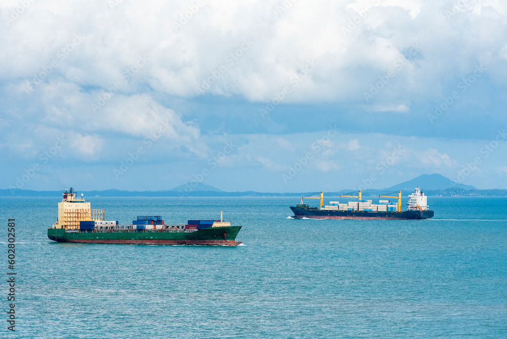 Cargo container ship sailing through peaceful, calm, blue sea on her voyage through the Singapore Strait. Cargo container ship sailing through peaceful, calm, blue sea on her voyage through the Singapore Strait.