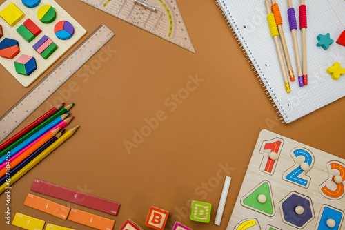 Fractions, rulers, pencils, notepad on brown background. Set of supplies for mathematics and for school. Back to school, fun education concept 