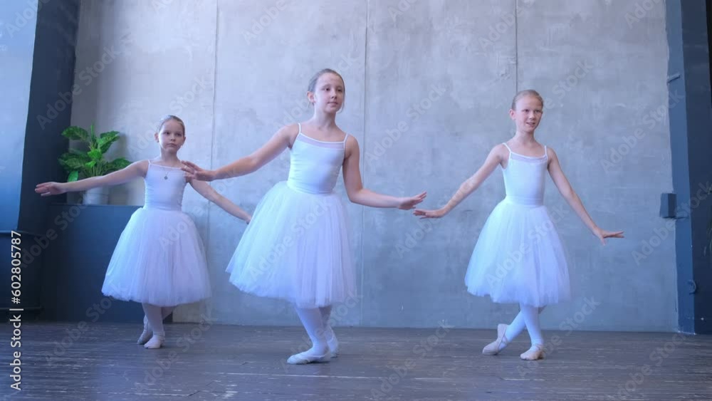 A girls dancer in a ballet school is learning to dance. Little ballerinas in training in a dance costume. Children's ballet school. 4K A girls dancer in a ballet school is learning to dance. Little ballerinas in training in a dance costume. Children's ballet school. 4K