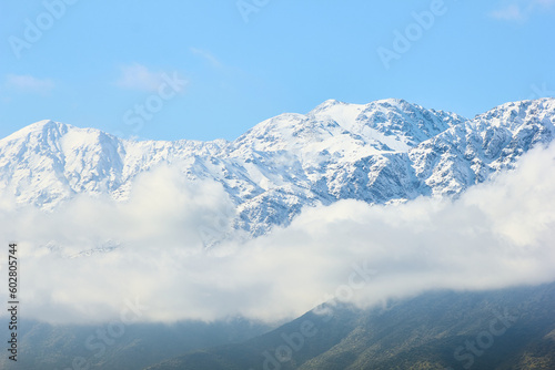 Snowy mountain range with clouds